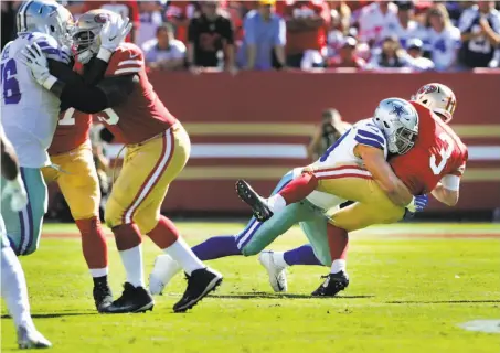  ?? Carlos Avila Gonzalez / The Chronicle ?? Quarterbac­k C.J. Beathard, in his first NFL start, is sacked by Dallas’ Tyrone Crawford in the first half of the Cowboys’ rout.