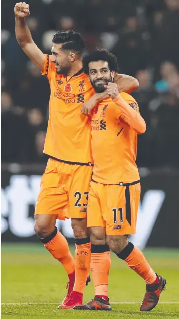  ??  ?? Liverpool's Mohamed Salah, right, celebrates with Emre Can after scoring his team’s fourth goal.