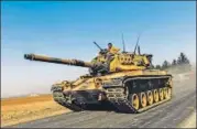  ??  ?? A Turkish army tank drives towards Syria on Wednesday.