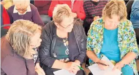  ??  ?? From left, Shirley Read, Joyce Lawrence and Helen Bayliss, having a go at answering the questions.