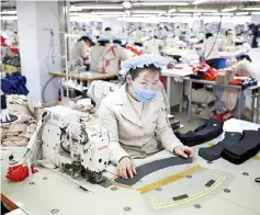  ??  ?? A North Korean employee works in a factory of a South Korean company at the Joint Industrial Park in Kaesong industrial zone, a few miles inside North Korea from the heavily fortified border in this file picture. — Reuters photo