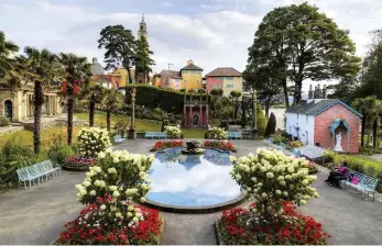  ??  ?? LEFT The village’s bright central piazza BELOW RIGHT A golden plaster-cast Buddha, a prop from the film The Inn of the Sixth Happiness (1958), in a grotto in Portmeirio­n