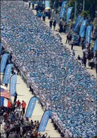  ?? AP/LIONEL CIRONNEAU ?? Employees of the Tiens Group, a Chinese company, parade in France earlier this month. About 6,000 employees were treated to a two-day trip to Paris and two-day trip to Nice, France.