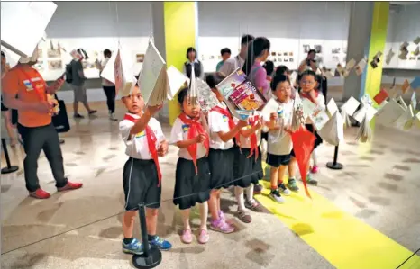  ?? PHOTOS PROVIDED TO CHINA DAILY ?? Top: An exhibition of cartoon books drew large numbers to the National Art Museum of China in Beijing last year. Above left and right: Exhibits in a recent exhibition at the museum. Above center: A work by Peng Wei.