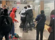  ?? WILL B WYLDE VIA AP ?? A person is aided outside a subway car in the Brooklyn borough of New York, Tuesday.