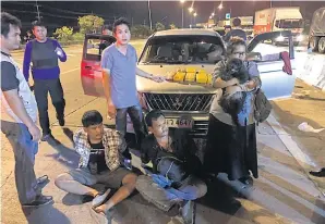  ??  ?? FAR LEFT Three members of the same family are arrested and about 50,000 speed pills seized from their pickup truck at a checkpoint on Rama II Road in Samut Sakhon province on Wednesday night.