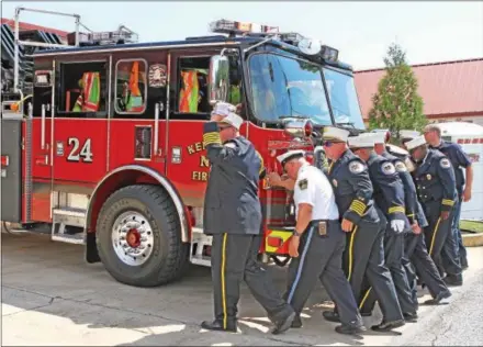  ?? CHRIS BARBER — DIGITAL FIRST MEDIA ?? Kennett Fire Company members go through the ritual of housing their new truck.