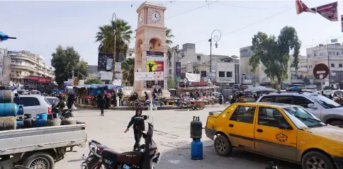  ??  ?? Syrians walk at a local market in the rebel-held northern Syrian city of Idlib. — AFP photo