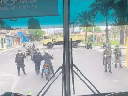  ?? KRISTEN SNYDER/COURTESY ?? On the bus ride to the Iquitos airport, Kristen Snyder, an American who was previously stuck in Peru after the country went into lockdown, snapped a photo of her bus passing through a checkpoint guarded by military and police officers.