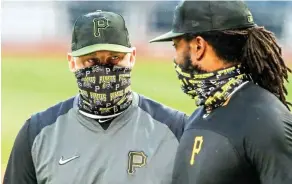  ?? AP Photo/Gene J. Puskar, File ?? ■ Pittsburgh Pirates first baseman Josh Bell, right, listens to manager Derek Shelton during a team workout Tuesday at PNC Park in Pittsburgh. Shelton and other first-year managers are scrambling to make up for lost time. The rookie skippers are getting creative when it comes to getting a feel for their players during a season unlike any other.
