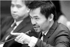  ??  ?? Philippine Senator and boxer Manny Pacquiao questions Lascanas (not pictured) during the Senate inquiry on alleged extra judicial killings. — Reuters photo