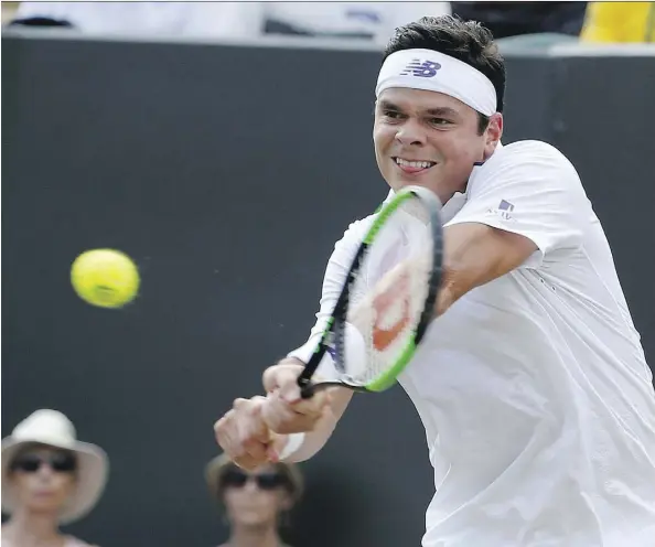  ?? ALASTAIR GRANT/THE ASSOCIATED PRESS ?? Milos Raonic returns the ball to Mikhail Youzhny during their match at Wimbledon in London on Thursday.