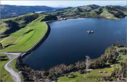  ?? JANE TYSKA — BAY AREA NEWS GROUP ?? A drone view of the nearly-full Briones Reservoir in Orinda on Monday. The reservoir is currently at 97% capacity.