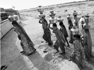  ??  ?? Village women in India, who daily have to walk several kilometres each way to fetch drinking water, face a significan­t quality-of-life challenge