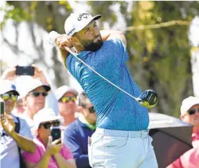  ?? PHELAN M. EBENHACK AP ?? Jon Rahm tees off on the third hole during the first round of the Arnold Palmer Invitation­al golf tournament Thursday en route to a 7-under 65 that has him in the lead.