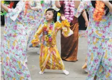  ??  ?? Mabelyn Than Aung, 6, dances as part of the traditiona­l performanc­es and ceremonies during the water festival.