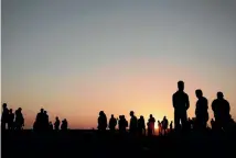  ?? PHOTO: AP ?? The sun sets over Palestinia­n protesters gathered at the Gaza Strip border with Israel, in eastern Gaza City, yesterday.