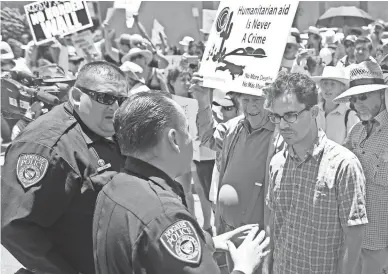  ?? PATRICK BREEN/THE REPUBLIC ?? Protesters block the street to the DeConcini port of entry temporaril­y halting access at the Families Belong Together march in Nogales on Saturday.