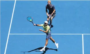  ?? PHOTO: GETTY IMAGES ?? Semis bound . . . Queenstown player Ben McLachlan (front) prepares to volley home a winner during his doubles quarterfin­al at the Australian Open in Melbourne yesterday. McLachlan and German JanLennard Struff beat top seeds Lukasz Kubot, of Poland,...