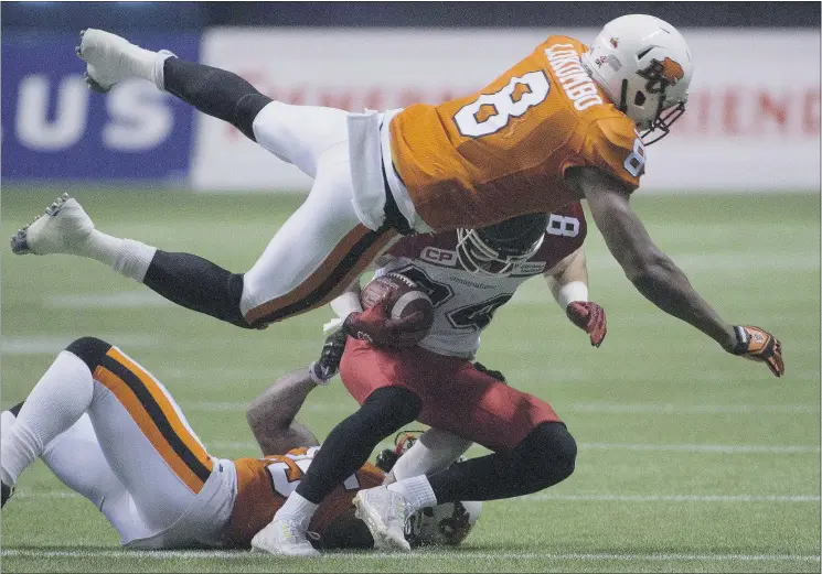  ?? — THE CANADIAN PRESS FILES ?? Lions’ Bo Lokombo tackles Calgary’s Greg Wilson during CFL action in Vancouver last year. The Lions drafted the linebacker in 2013.