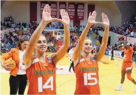  ?? DARRON CUMMINGS/ASSOCIATED PRESS ?? Miami’s Haley Cavinder (14) and Hanna Cavinder (15) celebrate after the Hurricanes defeated Indiana in the NCAA Tournament Monday in Bloomingto­n, Ind. The Fresno State transfers and major influencer­s are getting the last laugh on their critics.