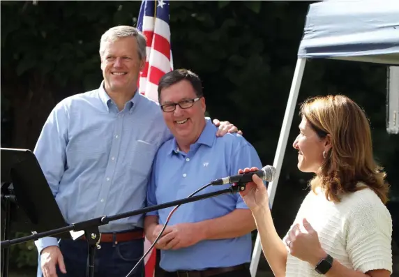  ?? JULIA MALAKIE / LOWELL SUN FILE ?? ALL TOGETHER: Gov. Charlie Baker embraces Rep. David Nangle while Lt. Gov. Karyn Polito speaks at Nangle’s September 2018 steak-andlobster fundraiser at Lenzi’s in Dracut.