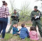  ?? COURTNEY SACCO/USA TODAY NETWORK ?? Agents take migrants into custody last week after they crossed from Mexico near Mission, Texas.