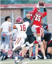  ??  ?? Carl Albert’s Jason Taylor makes a catch during a high school football scrimmage at Carl Albert in Midwest City on Thursday.