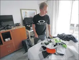  ??  ?? TOM-JELTE SLAGTER, a “domestique” on Team Dimension Data, prepares in his hotel room for a day of racing. “I understand my role,” he says.