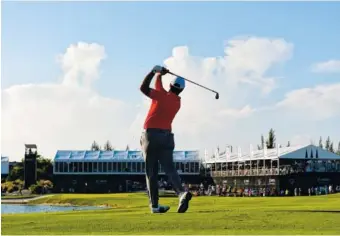  ?? AP PHOTO/DANTE CARRER ?? Spain’s Jon Rahm hits from the fairway of the 18th hole during the final round of the Hero World Challenge on Sunday at Albany Golf Club in Nassau, Bahamas. Rahm won by four shots.