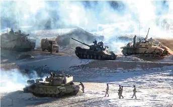  ?? — AFP file photo ?? People Liberation Army (PLA) soldiers and tanks during military disengagem­ent along the Line of Actual Control (LAC) at the India-China border in Ladakh.