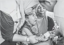  ?? ULET IFANSASTI GETTY IMAGES ?? A boy cries while receiving treatment at an emergency hospital in Lombok Island, Indonesia, on Friday.