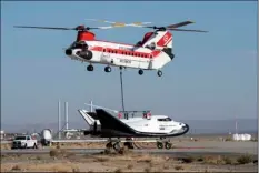  ?? PHOTO ?? This Nov. 11, 2017 photo provided by Sierra Nevada Corporatio­n shows the Dream Chaser spacecraft being lifted by a helicopter prior to a test flight at Edwards Air Force Base. The Sierra Nevada Corp., says its Dream Chaser had a successful free-flight...