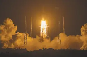  ?? Mark Schiefelbe­in / Associated Press ?? A rocket carrying the lunar mission launched last week from China’s southern Hainan Island. China is only the third nation to seek lunar samples.