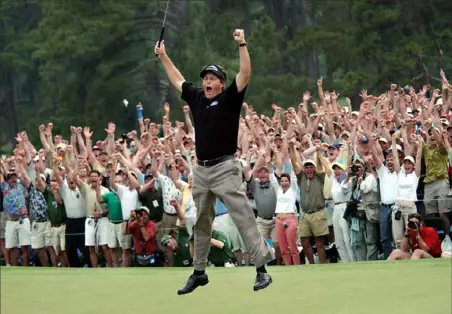  ?? Associated Press ?? Phil Mickelson leaves his feet in joy and relief after finally winning the Masters in 2004.