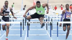  ??  ?? Dejour Russell (centre) winning the Boys Under-18 110-metre hurdles at the JAAA Carifta Trials ahead of Wayne Pinnock (right) Kingston College and Oquendo Bernard of Jamaica College yesterday at the National Stadium.