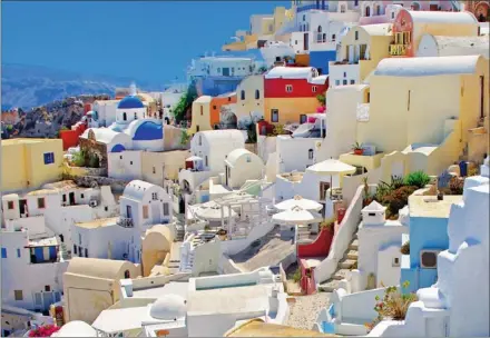  ??  ?? VIBRANT: Splashes of colour amid the otherwise whitewashe­d houses adds to the vibrancy of Santorini.