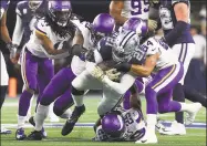  ?? Getty Images ?? Ezekiel Elliott of the Dallas Cowboys is brought down Sunday by members of the Minnesota Vikings at AT&T Stadium.