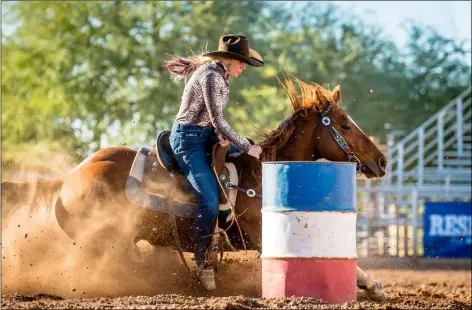  ?? PHOTO DAN LESOVSKY (WEASEL LOADER PHOTO) ?? Megan Champion steers through the barrel course at this weekend’s Cattle Call Rodeo in Brawley.
