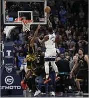  ?? ABBIE PARR – THE ASSOCIATED PRESS ?? Timberwolv­es guard Anthony Edwards shoots against Warriors forward Andrew Wiggins, left, on Wednesday.