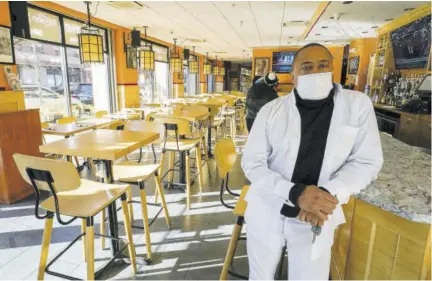  ?? (Photo: AP) ?? Andrew Walcott, owners of Fusion East Caribbean & Soul Food restaurant, poses for a photo at the restaurant in east New York neighbourh­ood of the Brooklyn borough of New York, Thursday, January 7, 2021. Walcott had to furlough four employees at his restaurant just before Christmas, after New York state stopped allowing indoor dining.