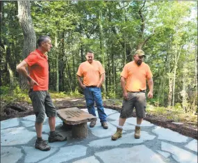  ?? Leslie Hutchison / Hearst Connecticu­t Media ?? From left, Matt Norton, organizer, with Marcus Catania and Craig Haskell, from the town's Department of Public Works. Norton led the effort to revitalize the Jones Mountain Preserve overlook, in memory of his wife Joni.