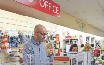  ??  ?? Tom Fleming at the post office counter.