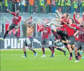  ?? ?? AC Milan players celebrate their win over Genoa, at the San Siro stadium in Milan on Friday,