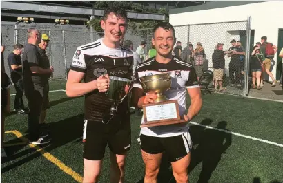  ??  ?? Sligo men Vinny Cadden (Coolera/Strandhill) and Darragh McConnon (Calry/St Joseph’s) celebrate with the Senior Championsh­ip and League trophies after Sligo GAA in New York won the double in 2019.