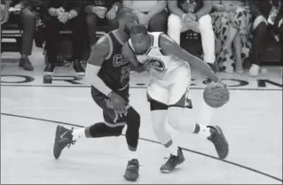  ?? RONALD MARTINEZ, GETTY IMAGES ?? Kevin Durant drives with the ball against LeBron James in Game 1 of the NBA final Thursday.