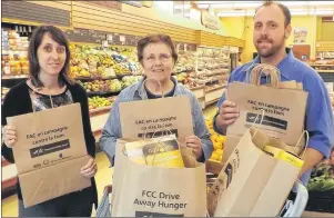  ?? SUBMITTED PHOTO ?? The annual food drive for the Summerside Salvation Army Food Bank will take place this year Oct. 10-19 in the Evangeline and surroundin­g regions. Officially launching the drive are, Diane McInnis from Évangéline-Central Credit Union, left, Angèle Arsenault and Rick Arsenault from Wellington Co-op.