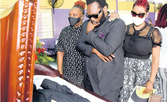  ?? KENYON HEMANS/PHOTOGRAPH­ER ?? Family members of the late Bobby Digital, (from left) Trudy-Ann Dixon, daughter; Craig Dixon, son; and niece, Peta-Gaye Black, say their final goodbyes at a thanksgivi­ng service held in his honour at Pembroke Hall High School on Saturday. The influentia­l music producer, real name Robert Dixon, died in May. He was 59.