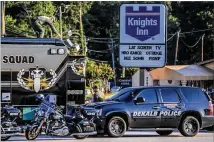  ?? JOHN SPIN K/ JSPINK@AJC.COM ?? DeKalb police evacuated guests, some clad only in towels and besheets, early Monday morning at the Knights Inn in the 2900 block of Lawrencevi­lle Highway, during a five-hour standoff with a robbery suspect. No one was injured.