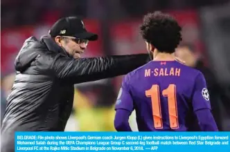  ??  ?? BELGRADE: File photo shows Liverpool’s German coach Jurgen Klopp (L) gives instructio­ns to Liverpool’s Egyptian forward Mohamed Salah during the UEFA Champions League Group C second-leg football match between Red Star Belgrade and Liverpool FC at the Rajko Mitic Stadium in Belgrade on November 6, 2018. — AFP